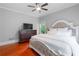 Comfortable bedroom featuring a large bed, dresser, and a ceiling fan at 1000 Admiral Xing, Alpharetta, GA 30005