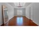 Dining room with hardwood flooring, crown molding, modern lighting fixture, and large window views at 1000 Admiral Xing, Alpharetta, GA 30005