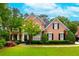 Charming two-story brick home with manicured lawn and mature landscaping at 1000 Admiral Xing, Alpharetta, GA 30005
