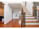 Open hallway with wooden staircase, decorative iron railing, and view to the powder room at 1000 Admiral Xing, Alpharetta, GA 30005