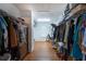 Walk-in closet with custom shelving and hanging rods providing ample storage space for clothing and accessories at 1000 Admiral Xing, Alpharetta, GA 30005