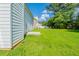 Expansive backyard featuring a lush green lawn and mature trees under a bright blue sky with scattered white clouds at 1013 Odelle Cir, Mcdonough, GA 30253