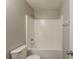 Clean bathroom featuring a shower-tub combo, toilet, and neutral wall color at 1013 Odelle Cir, Mcdonough, GA 30253