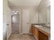 Open bathroom view with vanity and walk in to Primary bedroom with ceiling fan at 1013 Odelle Cir, Mcdonough, GA 30253