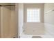 Bathroom with shower and tub with a window at 1013 Odelle Cir, Mcdonough, GA 30253