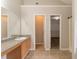 Well-lit bathroom featuring a granite countertop vanity, ceramic tile flooring, and convenient storage cabinets at 1013 Odelle Cir, Mcdonough, GA 30253
