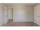 Bedroom featuring neutral walls, carpet, and an open door at 1013 Odelle Cir, Mcdonough, GA 30253