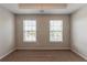 Bright bedroom with two windows, carpet and a ceiling fan at 1013 Odelle Cir, Mcdonough, GA 30253