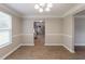 Open dining room featuring modern wood flooring, chair rail and large bright window at 1013 Odelle Cir, Mcdonough, GA 30253