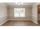 Open dining room with modern wood flooring and a bright window at 1013 Odelle Cir, Mcdonough, GA 30253