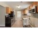 Galley kitchen with stainless steel appliances and light wood cabinets, ready for renovation at 1013 Odelle Cir, Mcdonough, GA 30253