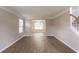 Open-concept living room with hardwood floors, offering a seamless transition to the dining area at 1013 Odelle Cir, Mcdonough, GA 30253