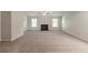 Spacious living room featuring neutral walls, carpet, and a fireplace at 1013 Odelle Cir, Mcdonough, GA 30253
