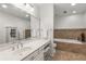 Luxurious bathroom with dual sinks, a spacious countertop, and a soaking tub at 1105 Clairemont Ave # O, Decatur, GA 30030