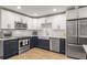 Updated kitchen with stainless appliances, navy lower cabinets, white upper cabinets, and farmhouse sink at 1105 Clairemont Ave # O, Decatur, GA 30030