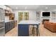 Open kitchen features white cabinets, stainless appliances, large island, and connects to the living room at 1105 Clairemont Ave # O, Decatur, GA 30030