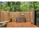 Charming patio area featuring brick pavers, wooden fence, and a cozy bench for outdoor relaxation at 1105 Clairemont Ave # O, Decatur, GA 30030