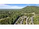 Picturesque aerial view of homes surrounded by dense forests, offering privacy and scenic mountain views at 1210 Magnolia Park Cir, Cumming, GA 30040