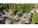 Aerial view showcases the neighborhood's layout, featuring tree-lined streets and well-maintained homes at 1210 Magnolia Park Cir, Cumming, GA 30040