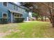 Lush backyard features a well-maintained lawn, privacy fence, and a cozy patio area at 1210 Magnolia Park Cir, Cumming, GA 30040