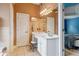Bathroom vanity featuring white cabinets, granite countertop, and ample storage space at 1210 Magnolia Park Cir, Cumming, GA 30040