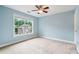 Bedroom with large window offering views of the landscaped backyard at 1210 Magnolia Park Cir, Cumming, GA 30040
