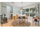 Sunlit dining area featuring a round table, chandelier, and views of the backyard at 1210 Magnolia Park Cir, Cumming, GA 30040