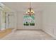 The elegant dining room features decorative wainscoting, an elegant chandelier, and a large front-facing window at 1210 Magnolia Park Cir, Cumming, GA 30040