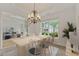 Formal dining room with elegant chandelier and ample seating adjacent to the formal living room at 1210 Magnolia Park Cir, Cumming, GA 30040