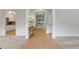 Warm foyer leading to the kitchen with hardwood floors, accent table, and large windows at 1210 Magnolia Park Cir, Cumming, GA 30040