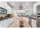 This kitchen has granite counters, stainless steel appliances, white cabinets, and a butcher block island at 1210 Magnolia Park Cir, Cumming, GA 30040