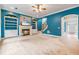 Comfortable living room with fireplace, built-in shelving, and an open entryway at 1210 Magnolia Park Cir, Cumming, GA 30040