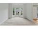 Bright living room with large bay window and neutral carpeting throughout with view of the front yard at 1210 Magnolia Park Cir, Cumming, GA 30040