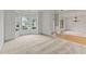 The living room boasts a large bay window, plush carpeting, and an open layout to the dining room at 1210 Magnolia Park Cir, Cumming, GA 30040