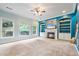 Bright living room featuring built-in shelves, fireplace, and large windows at 1210 Magnolia Park Cir, Cumming, GA 30040