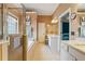 The bright main bathroom features double sinks, a soaking tub, a shower and neutral decor at 1210 Magnolia Park Cir, Cumming, GA 30040