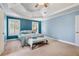 The spacious main bedroom features a tray ceiling, blue walls and carpeted floors at 1210 Magnolia Park Cir, Cumming, GA 30040