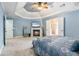 The spacious main bedroom features a tray ceiling, fireplace, and a doorway to the main bathroom at 1210 Magnolia Park Cir, Cumming, GA 30040