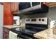 Modern kitchen featuring granite countertops, stainless steel appliances, and dark wood cabinets at 1280 W Peachtree Nw St # 3602, Atlanta, GA 30309