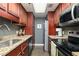 Well-equipped kitchen with granite countertops, stainless steel appliances, and dark wood cabinets at 1280 W Peachtree Nw St # 3602, Atlanta, GA 30309