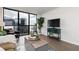 Bright living room with expansive city views and modern furnishings at 1280 W Peachtree Nw St # 3602, Atlanta, GA 30309