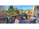 Outdoor deck featuring a grill, tables, and wooded views with the perfect space for entertaining guests at 4520 Essen Lane, Cumming, GA 30041