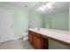 Mint green bathroom featuring a long vanity, bright lighting, and a walk-in shower at 2656 Avanti Way, Decatur, GA 30035