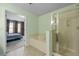 Bathroom with shower, soaking tub, and doorway to the primary bedroom at 2656 Avanti Way, Decatur, GA 30035