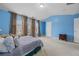 Spacious blue bedroom with plush carpet and large windows, perfect for relaxing at 2656 Avanti Way, Decatur, GA 30035