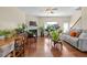 Open-concept living room with hardwood floors and plants at 2656 Avanti Way, Decatur, GA 30035