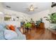 Open-concept living room with hardwood floors, ceiling fan, and archways to dining room at 2656 Avanti Way, Decatur, GA 30035