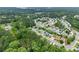 An aerial view shows a lush residential community surrounded by trees, offering serene suburban living at 336 Parc Xing, Acworth, GA 30102