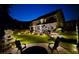 An entertainer's backyard features a patio, lush landscaping, and ambient lighting for evening enjoyment at 336 Parc Xing, Acworth, GA 30102