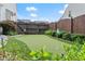 A putting green in backyard with flag poles in a fenced yard at 336 Parc Xing, Acworth, GA 30102